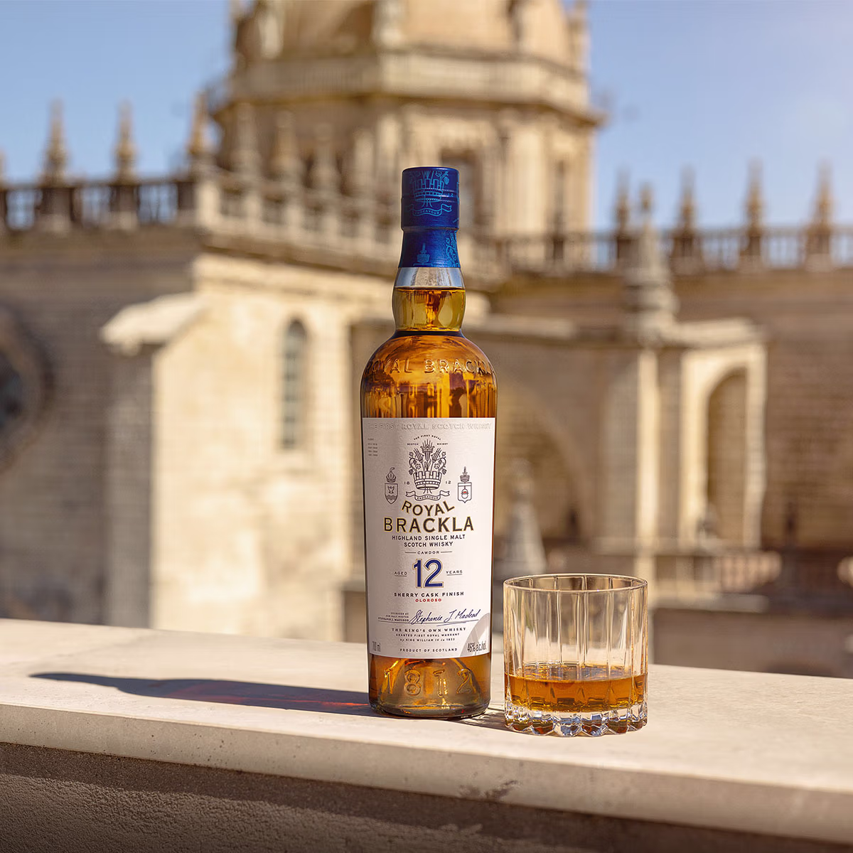 Bottle of Royal Brackla 12-year-old Highland Single Malt Scotch Whisky with glass of whisky.